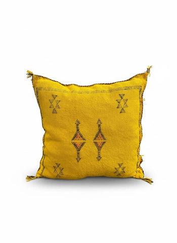 Yellow Moroccan Sabra pillow with black tribal motifs on white background