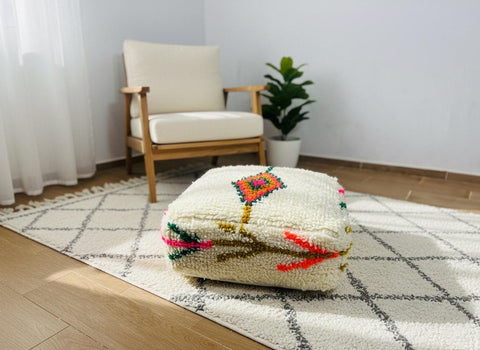 Cream Moroccan wool pouf with colorful motifs