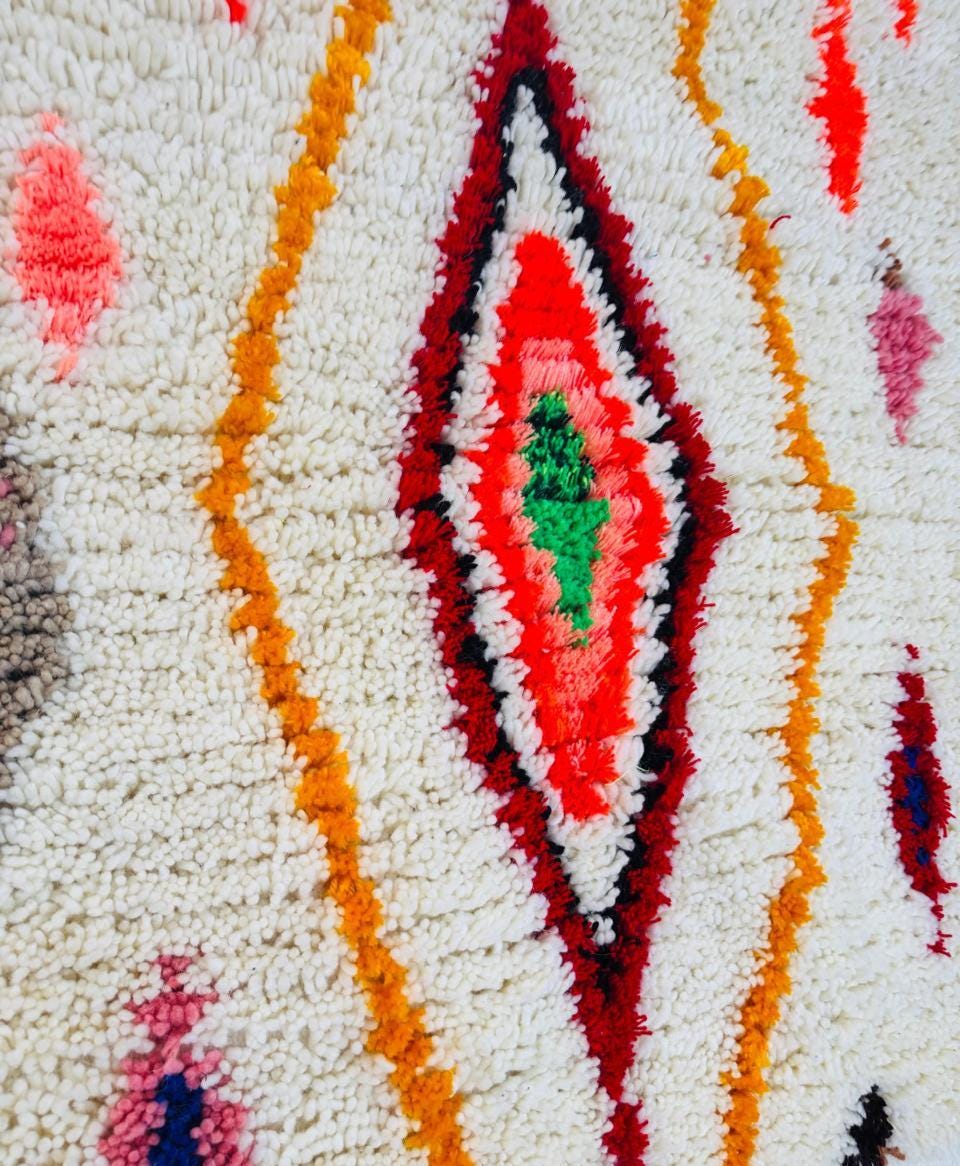 Contemporary Berber rug with vibrant diamond designs styled in a minimalist living room