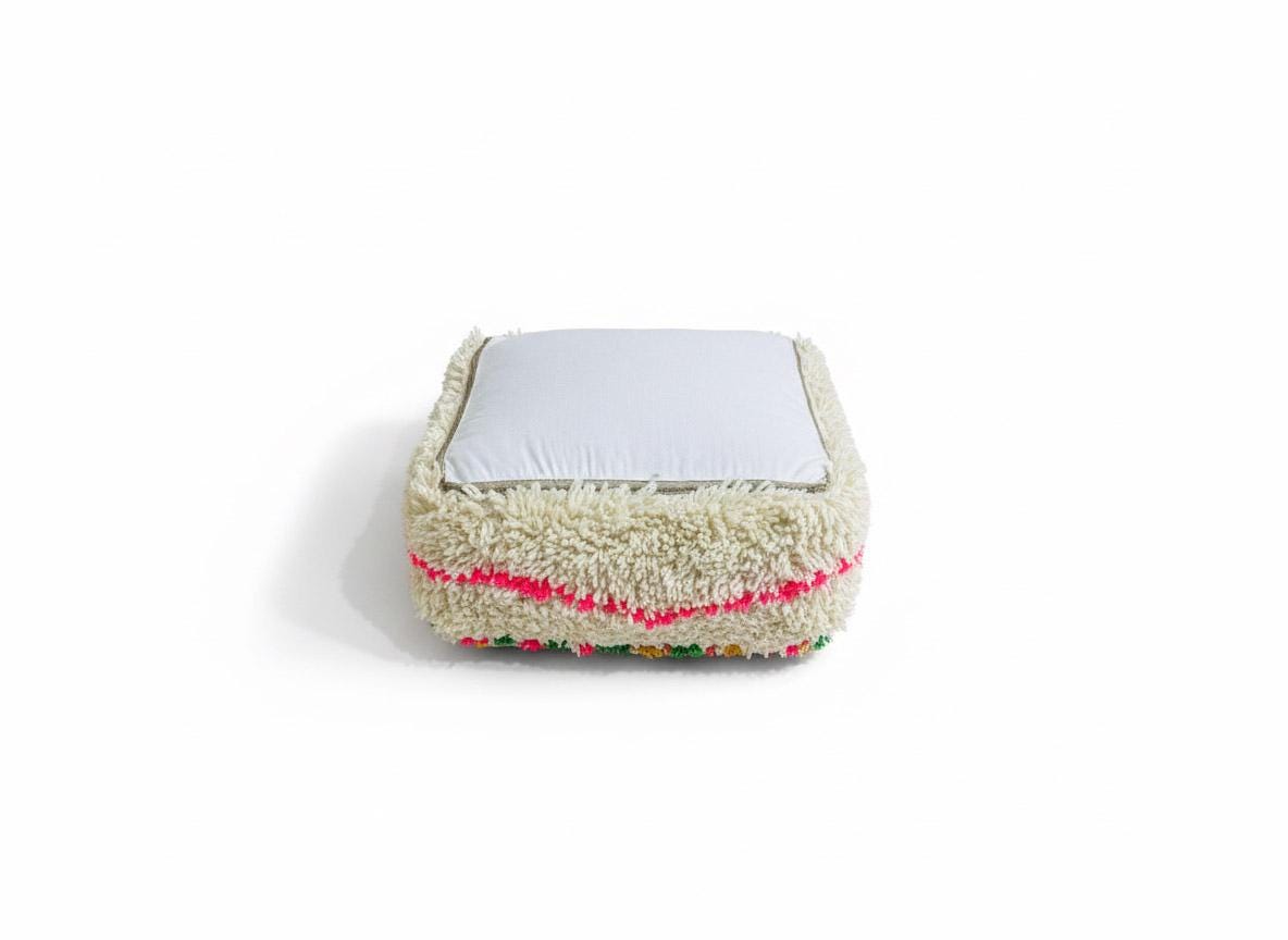 Handmade colorful Berber wool pouf on white background