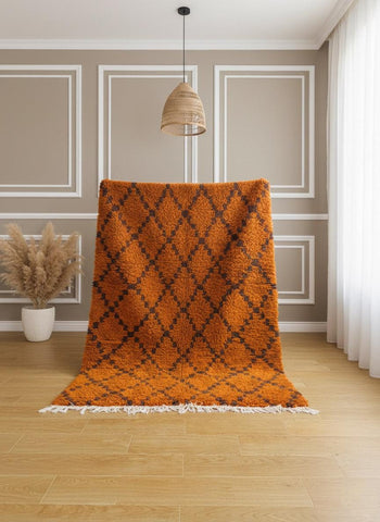 Orange Moroccan wool rug displayed upright