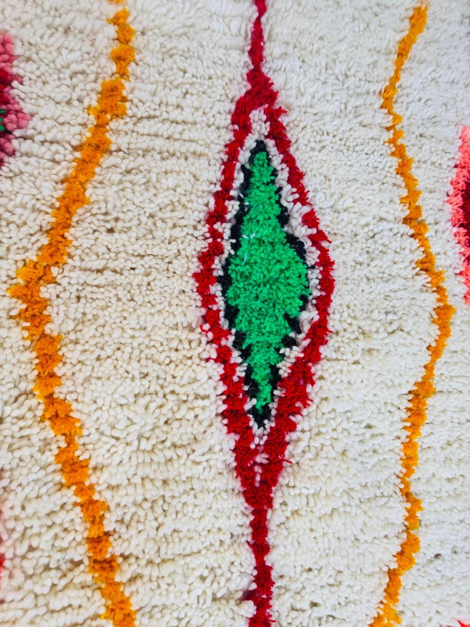 Handmade Moroccan wool rug displayed in a modern kitchen with colorful geometric Berber patterns