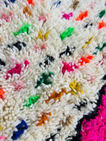 Close-up of pink diamond detail on handmade wool Berber rug