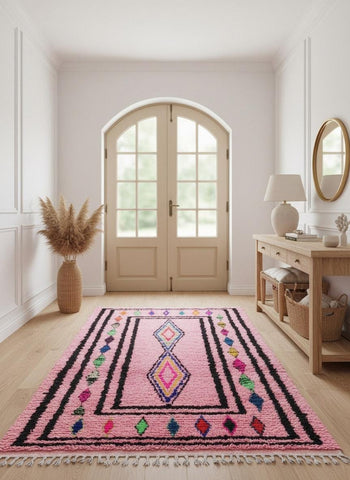 Handwoven pink diamond rug displayed in entryway