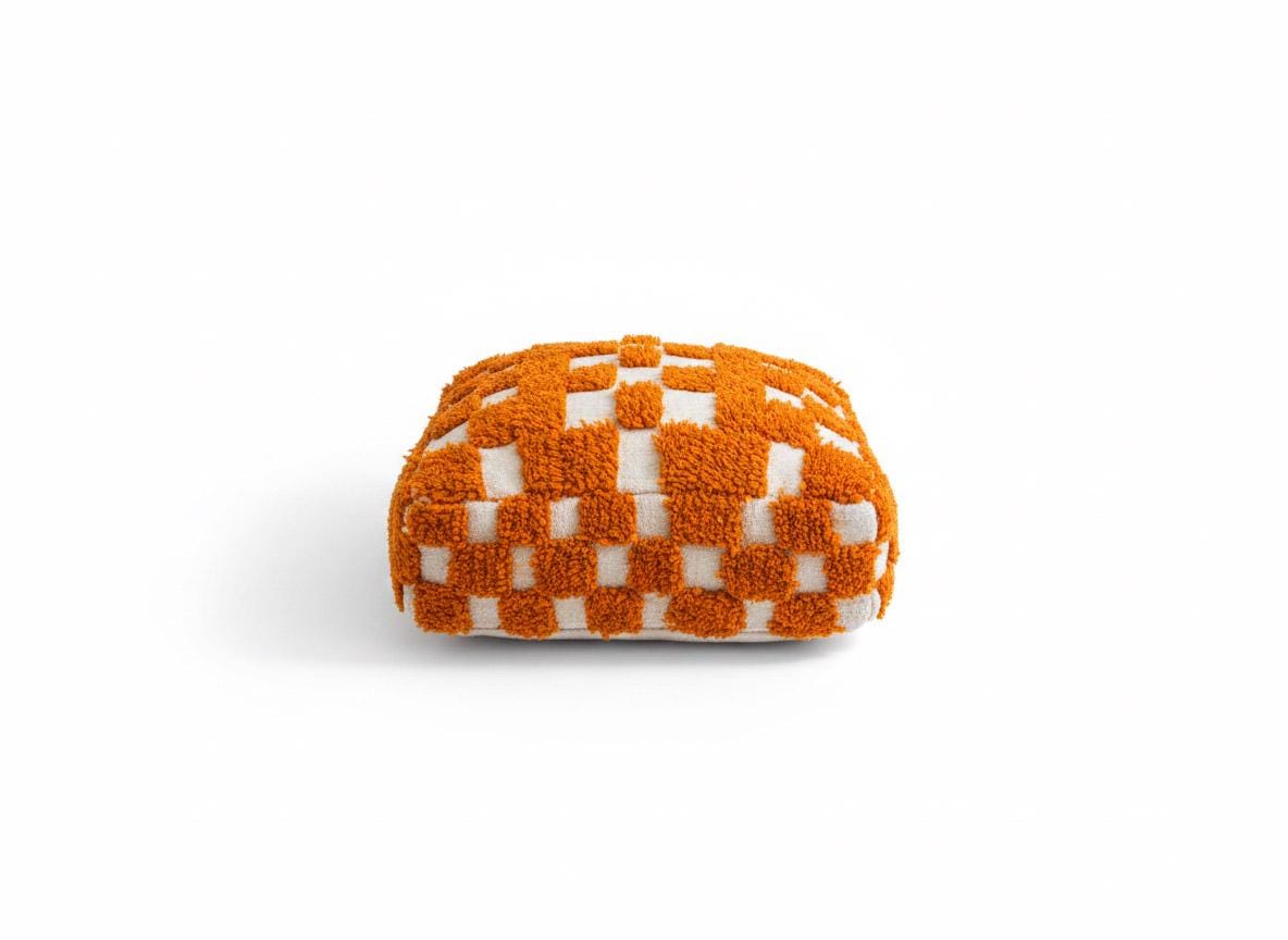 Orange and white handmade Moroccan pouf isolated on white background