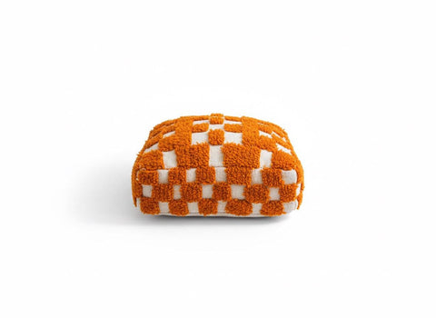 Orange and white handmade Moroccan pouf isolated on white background