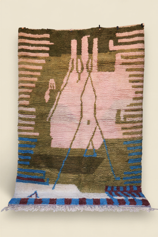 Full view of a Moroccan Berber rug with pink, olive green, and blue abstract geometric design and fringed edges