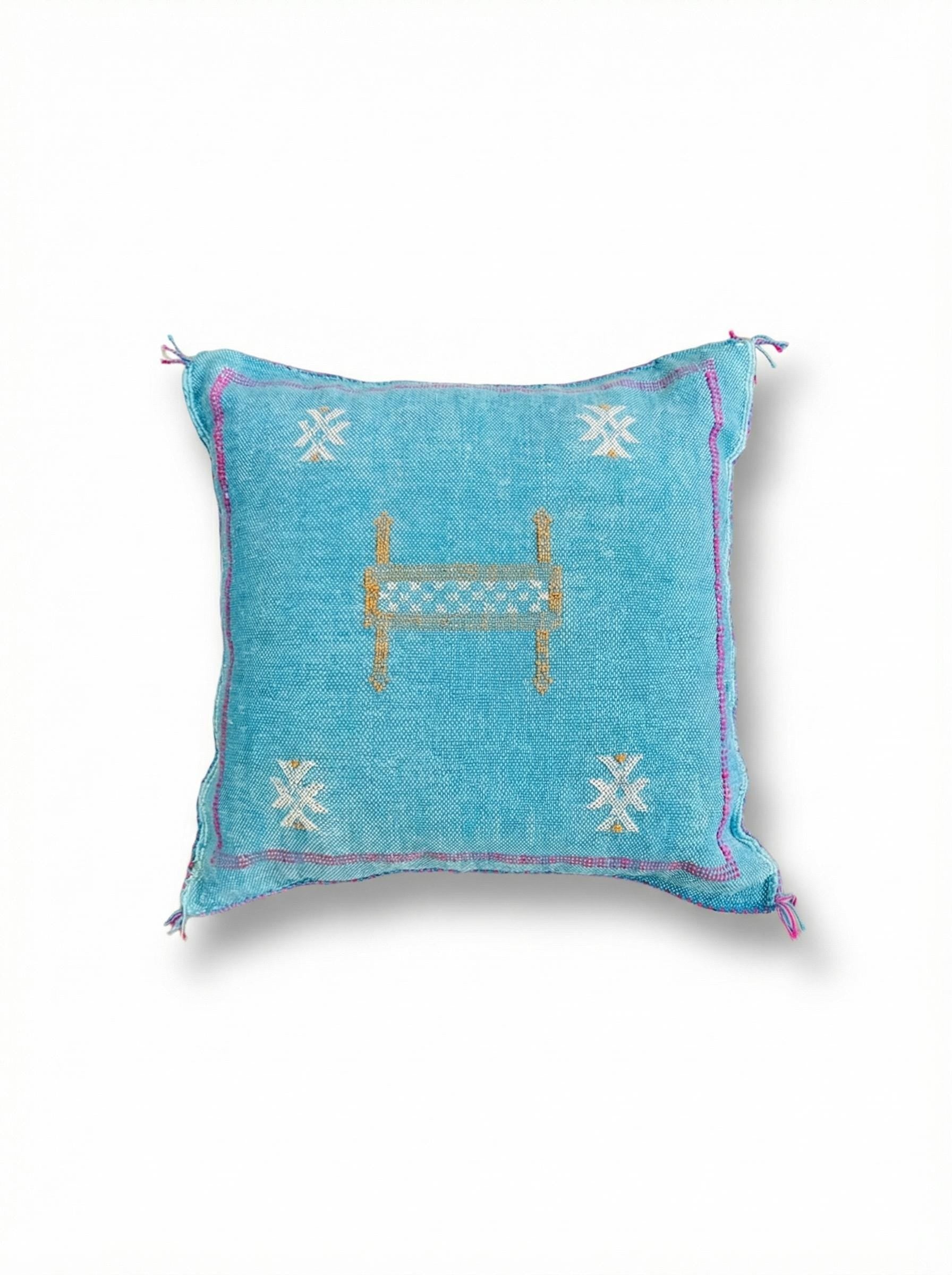 Teal blue cactus silk cushion cover with Berber symbols isolated