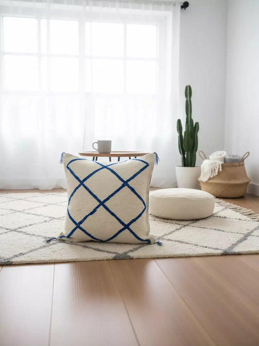 Blue and white Moroccan pillow on wool rug with cactus decor