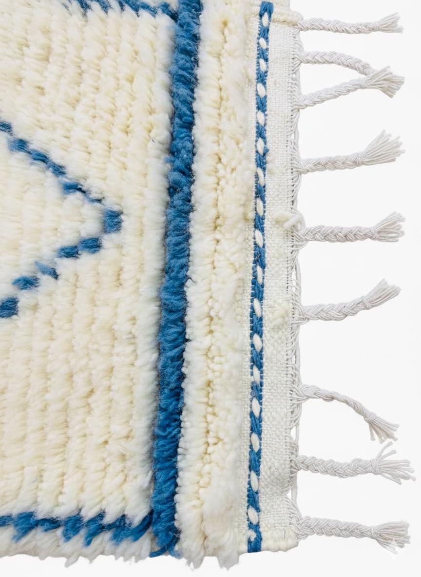 Detailed texture of ivory wool pile with blue pattern