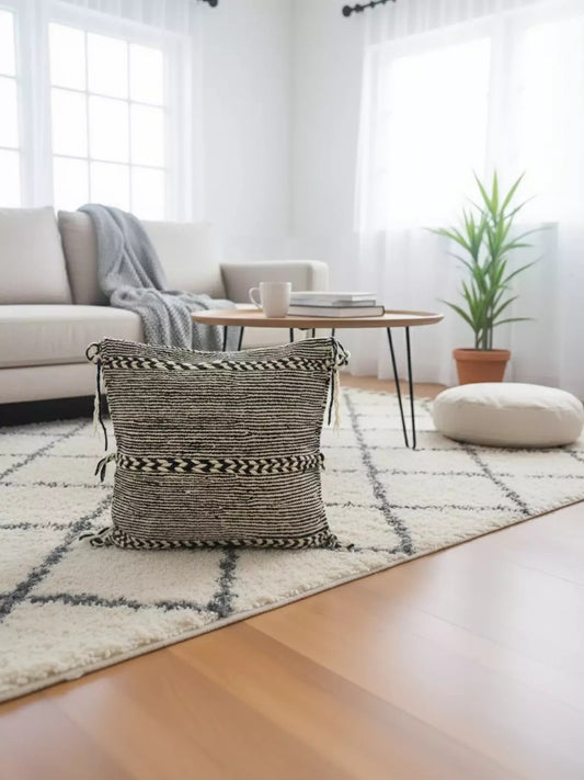 Handwoven Tisra Moroccan pillow on rug in cozy living room decor setting