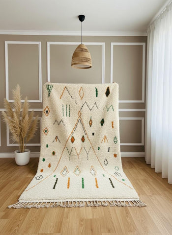 Close-up of cream Moroccan wool rug with green and mustard geometric details
