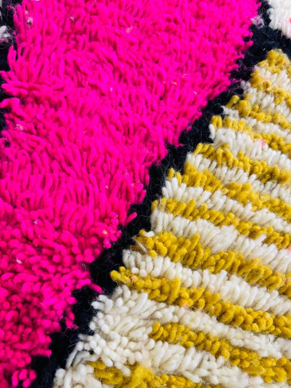 Close-up of pink diamond detail on handmade wool Berber rug