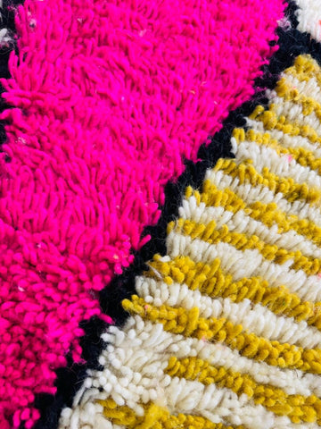 Close-up of pink diamond detail on handmade wool Berber rug