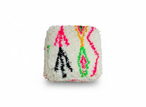 Handmade colorful Berber wool pouf on white background