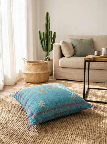 Blue Moroccan cactus silk pillow with geometric motifs on rug