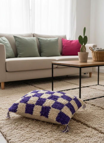 Handmade Moroccan purple checkered wool pillow styled on a living room rug.