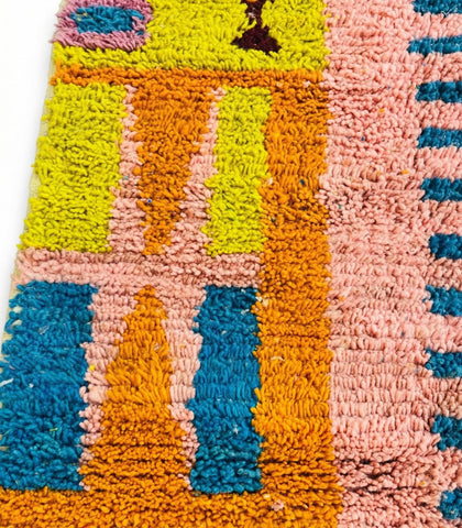 Detailed view of handmade Moroccan rug with vibrant patterns