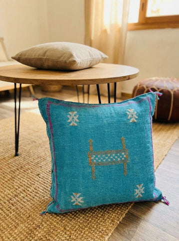 Blue Berber pillow with geometric design in cozy interior