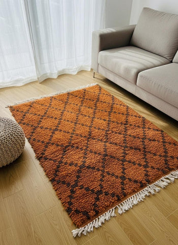 Handmade orange Moroccan rug with geometric pattern