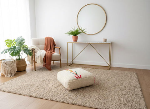 Berber embroidered floor pouf on neutral area rug