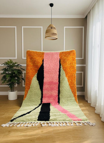Colorful Moroccan wool rug with pink, orange, green, and black geometric design