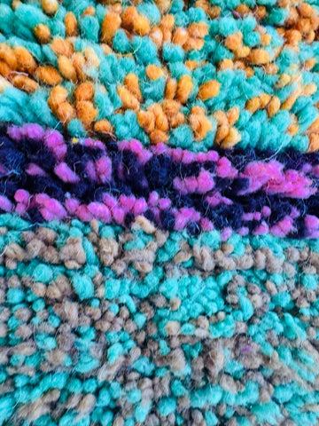 Thick pile Berber rug with colorful horizontal stripes.