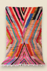 Moroccan Boucherouite rug featuring vivid rainbow-like zigzag patterns and soft wool texture