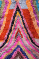 Close-up of vibrant Moroccan rug showcasing thick, textured wool weave and abstract design