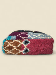 Side View of Berber Asirem Pouffe shows berber motifs and pink wool 