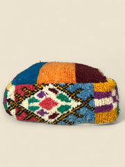 Side view highlighting tribal geometric motifs on Asmoun pouffe