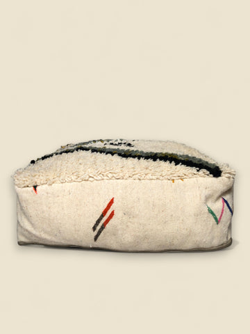 Third pouffe side with red and brown stitched stripes on off-white wool