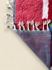 Underside of the Timlilit Moroccan rug showing handwoven backing and fringe