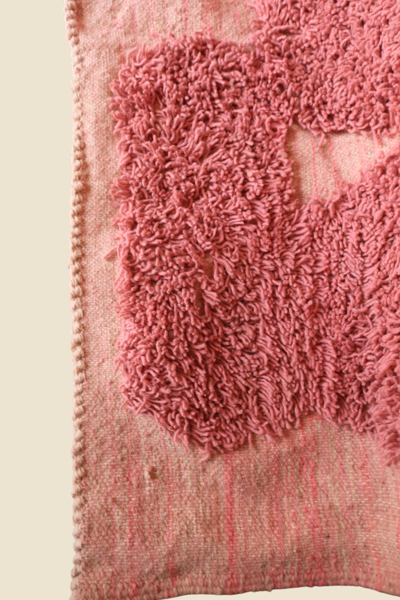 Close-up of rug corner showing handwoven edge and high-pile wool texture