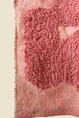 Close-up of rug corner showing handwoven edge and high-pile wool texture