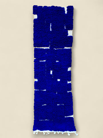 Blue textured rug on a beige background