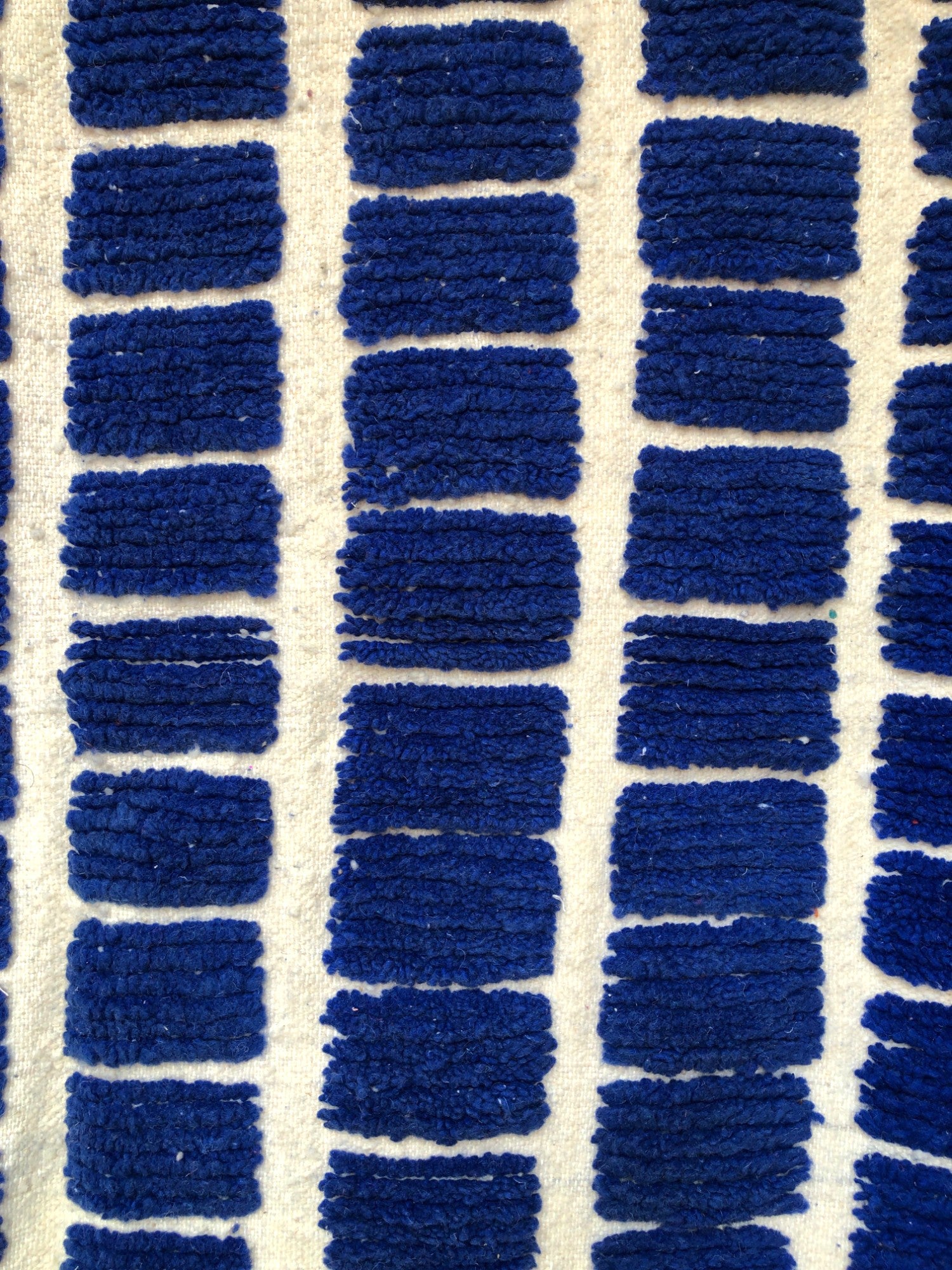 Grid pattern detail of the Tanit Moroccan rug in deep blue and white