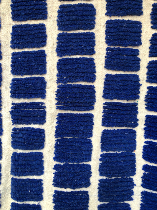 Grid pattern detail of the Tanit Moroccan rug in deep blue and white