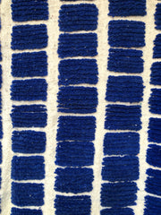 Grid pattern detail of the Tanit Moroccan rug in deep blue and white