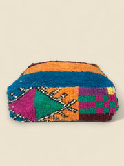 Side view highlighting tribal geometric motifs on Asmoun pouffe