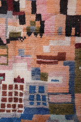 Close detail of artisan-made Temzine rug with pastel and dark wool blends