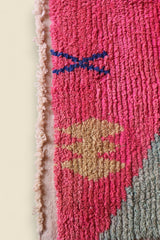 Bottom corner of the rug with tribal yellow motif and soft green section