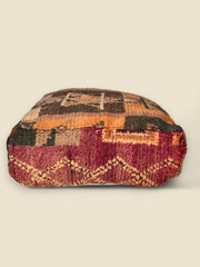 Earthy wool Moroccan pouffe with kilim-style symbols and rustic colors
