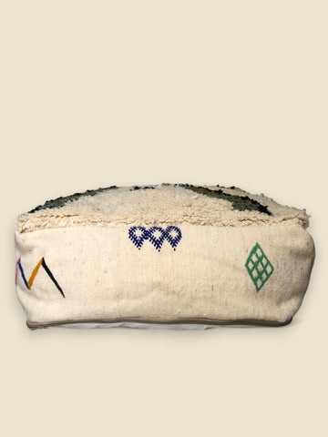 Alternate side of pouffe with purple heart-style pattern and green diamonds