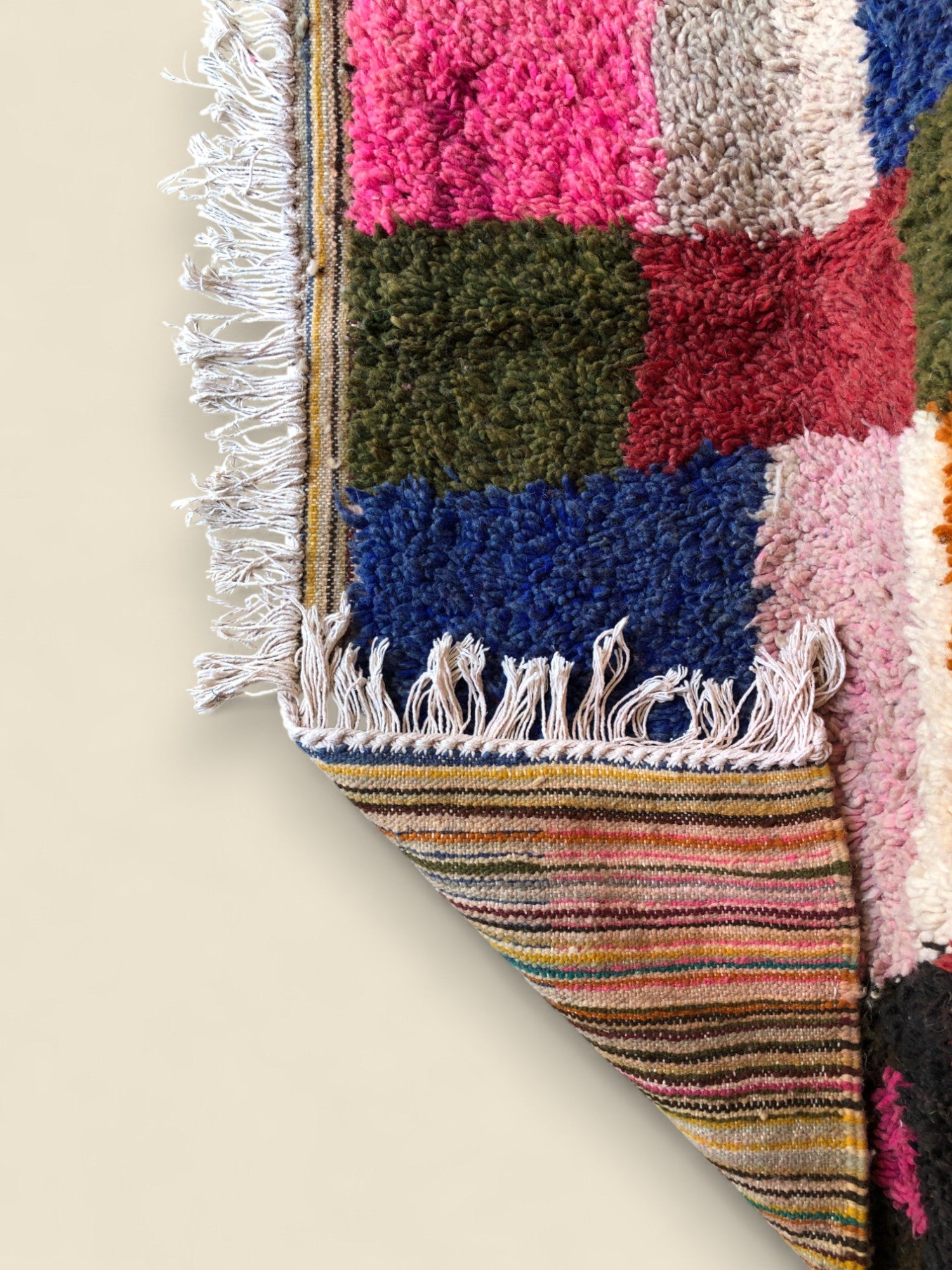 Reversible view showing striped flatwoven back and fringe detail

