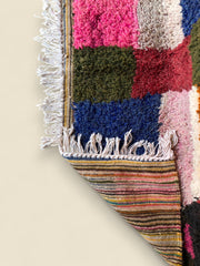 Reversible view showing striped flatwoven back and fringe detail

