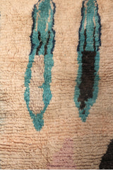 Top section detail of the Hafna rug featuring elongated teal and black forms.
