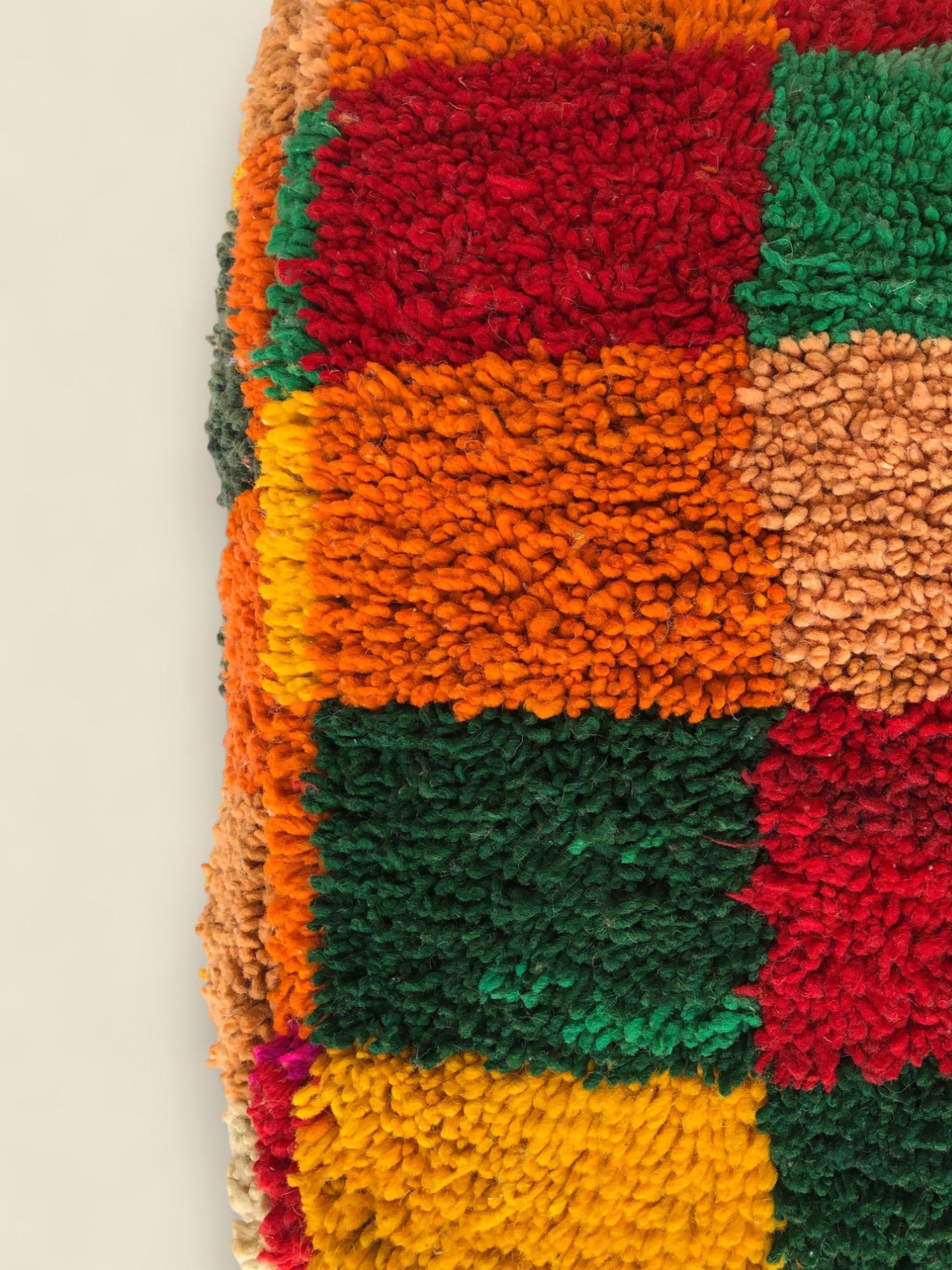 Close-up of the wool texture and geometric patchwork on Tirga Moroccan pouffe