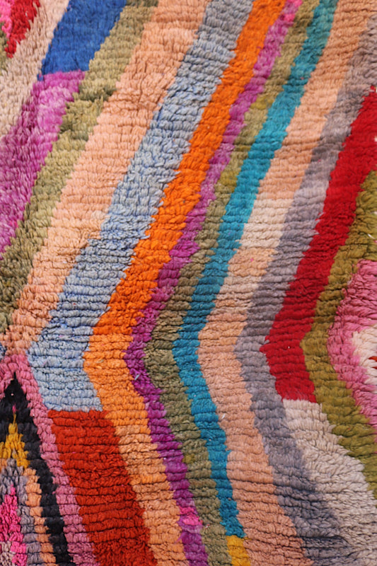 Handmade wool Berber rug with geometric chevrons in bright colors and natural fringe