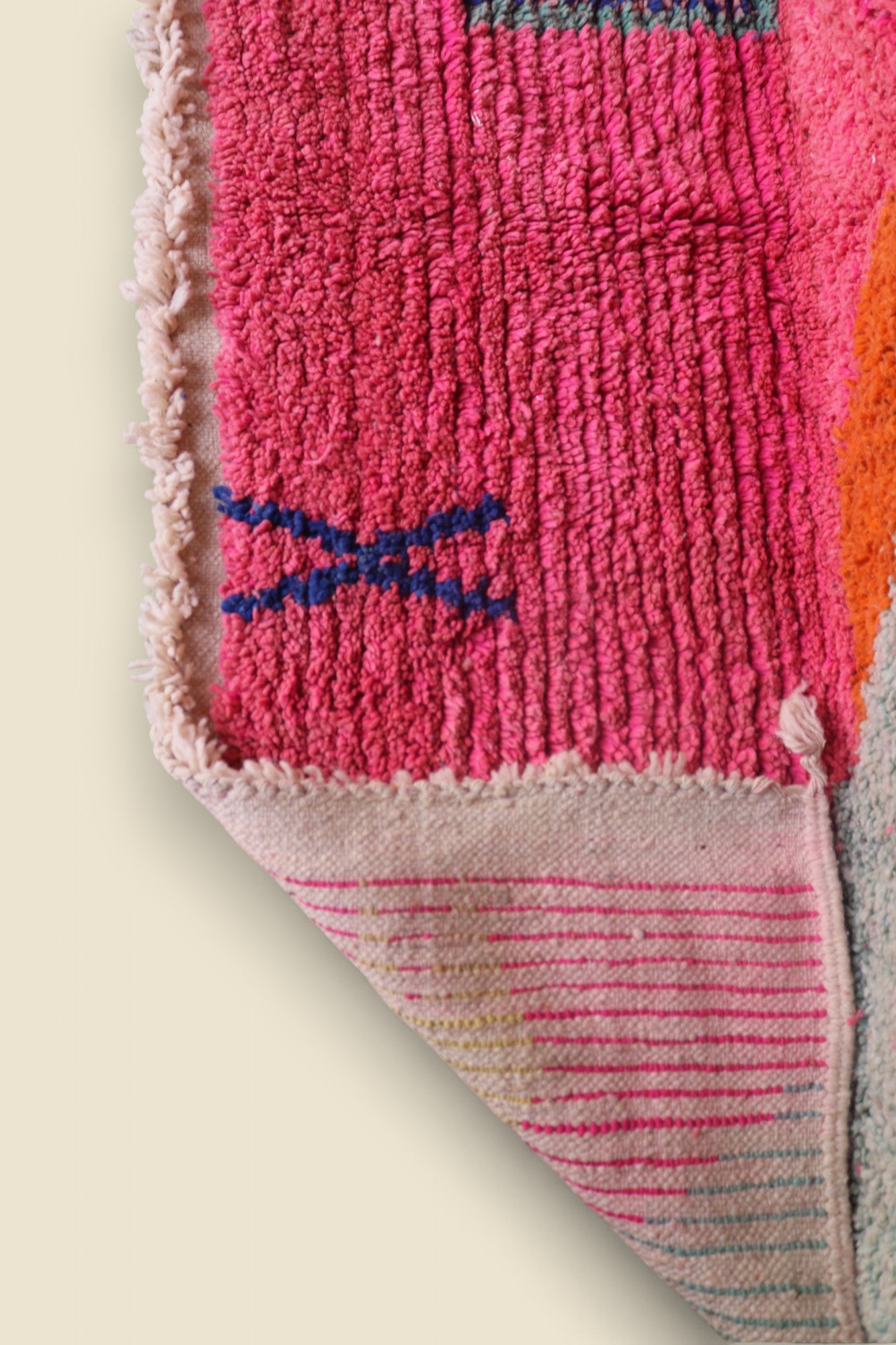 Close-up of Zafira rug showing texture and Berber blue cross symbol on pink